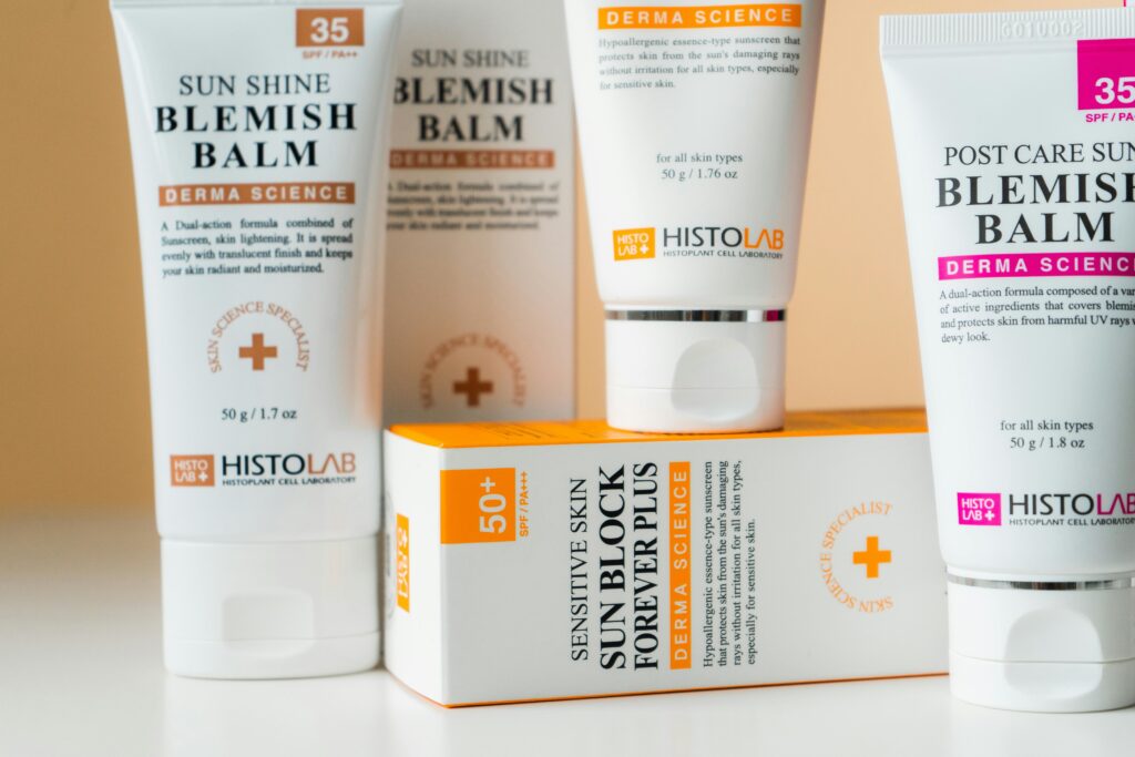 A clean and organized display of SPF skincare products focusing on blemish balm and sunblock.